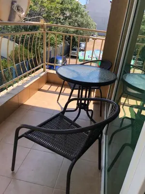 a table and chairs on a balcony with a view at Първа Линия Лазур Поморие in Pomorie