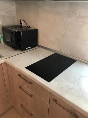 a kitchen with a counter top with a microwave at Първа Линия Лазур Поморие in Pomorie