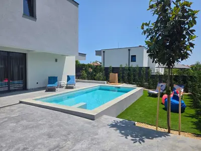 a swimming pool in the backyard of a house at Villa Cadaques, private pool with heating and salt water in Lozenets