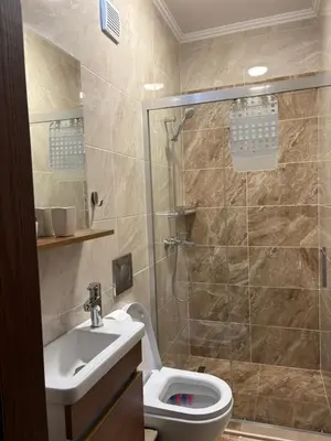 a bathroom with a shower and a toilet and a sink at Hogo Fogo in Burgas City