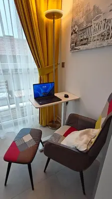 a room with a desk with a laptop and a chair at Vivid Sea and City Luxury Studio 2 plus 2 in Burgas City