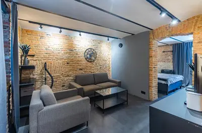 a living room with a couch and a bed at Skyler 9 in Varna City