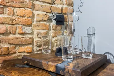 a bunch of glasses sitting on a wooden table at Skyler 9 in Varna City