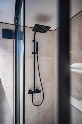 a shower in a bathroom with a shower head at Skyler 9 in Varna City