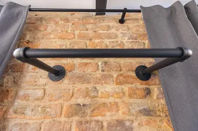 a black metal rack on a brick wall at Skyler 9 in Varna City