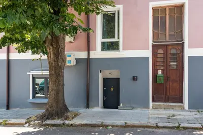 a pink and blue building with a door and a tree at Skyler 9 in Varna City