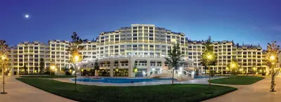 a large building with a courtyard in front of it at АТ apartment - South Bay Beach Residence in Varna City