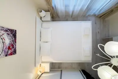a small kitchen with a refrigerator and a window at АТ apartment - South Bay Beach Residence in Varna City