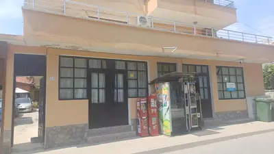 a building with two vending machines in front of it at Rooms Ivanka Ground Floor in Obzor