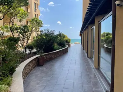 a walkway between two buildings next to the ocean at Beachfront Apartment Oasis VIP Club in Sunny Beach