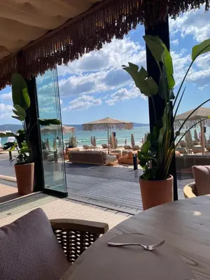a restaurant with a table with a view of the beach at Beachfront Apartment Oasis VIP Club in Sunny Beach