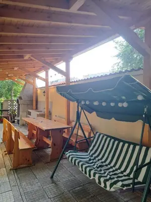 a picnic table and a bench under a roof at Family Hotel California in Primorsko