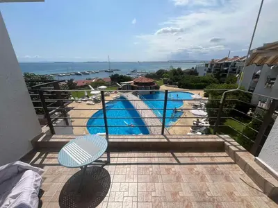 a balcony with a view of a swimming pool at Private apartment in complex Diamond in Sveti Vlas
