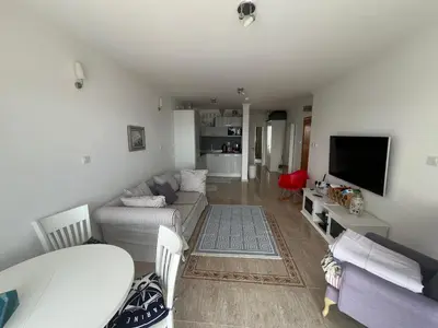 a living room with a couch and a table at Private apartment in complex Diamond in Sveti Vlas