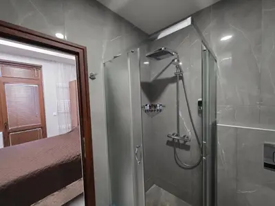 a bathroom with a shower with a glass door at DN Kiten in Kiten