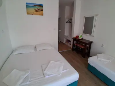 a bedroom with two beds and a desk and a mirror at Sunny Island Obzor in Obzor