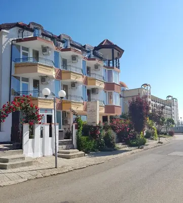 a tall building on the side of a street at Sunny Island Obzor in Obzor