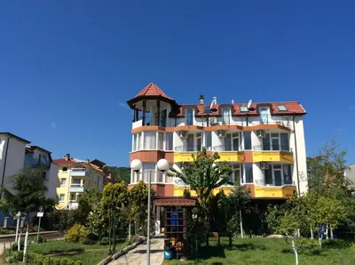 a large yellow and white building with a gazebo at Sunny Island Obzor in Obzor