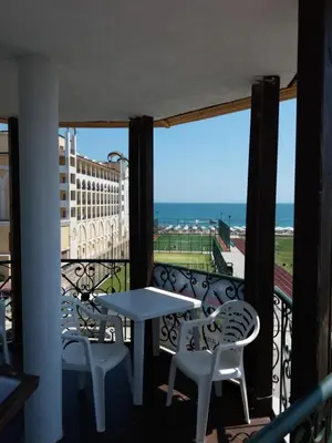 a balcony with a table and chairs and a view of the ocean at Sunny Island Obzor in Obzor