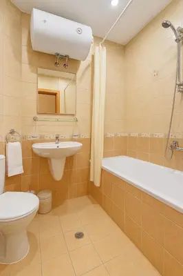 a bathroom with a toilet and a sink and a bath tub at Velika Garden Villas 1 bedroom apartment, Lozenets in Lozenets