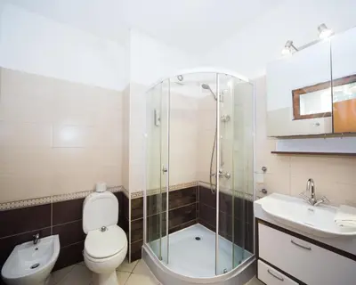 a bathroom with a toilet and a shower and a sink at Lovely 2 bedrooms Flat - 1st line Central Beach Lozenets in Lozenets