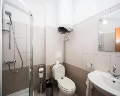 a bathroom with a shower and a toilet and a sink at Lovely 2 bedrooms Flat - 1st line Central Beach Lozenets in Lozenets