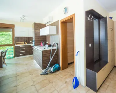 a kitchen with a vacuum in the middle of a room at Lovely 2 bedrooms Flat - 1st line Central Beach Lozenets in Lozenets
