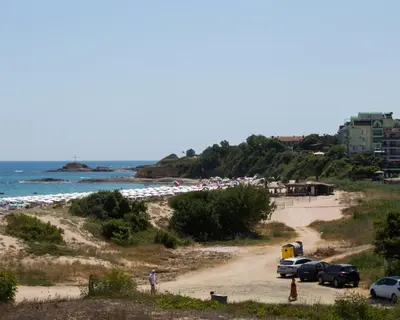a beach with cars parked on a dirt road at Lovely 2 bedrooms Flat - 1st line Central Beach Lozenets in Lozenets