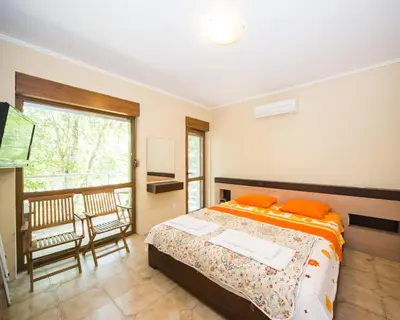 a bedroom with a bed and a balcony at Lovely 2 bedrooms Flat - 1st line Central Beach Lozenets in Lozenets