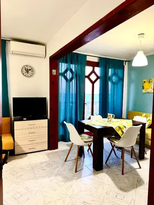 a living room with a dining room table and chairs at Villa Nikoleta in Sveti Vlas