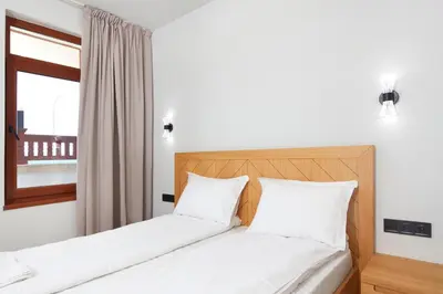 a bedroom with two beds and a window at Семеен хотел НОА in Nesebar