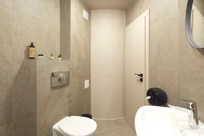 a bathroom with a toilet and a sink at Семеен хотел НОА in Nesebar