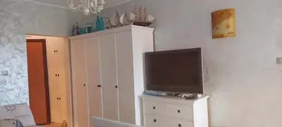 a tv sitting on top of a white cabinet at Delfin beach studio in Sozopol