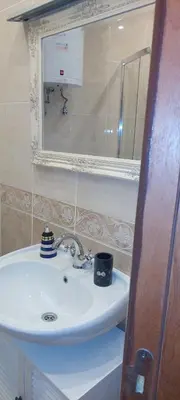 a bathroom with a white sink and a mirror at Delfin beach studio in Sozopol