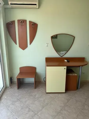 a room with a desk and a mirror on the wall at Хотел Грация in Lozenets
