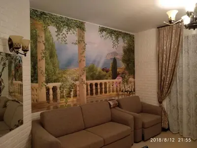 a living room with a couch and a painting on the wall at Элитные апартаменты у моря in Lozenets