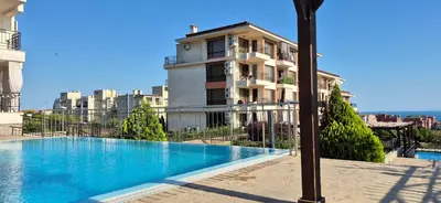 a building with a swimming pool in front of a building at Apartment Sofia Macon Residence Sveti Vlas in Sveti Vlas