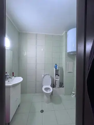 a bathroom with a toilet and a sink at морско бижу in Byala