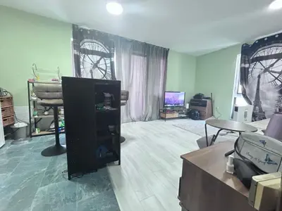 a living room with a tv and a couch at морско бижу in Byala