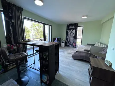 a living room with a table and a couch at морско бижу in Byala