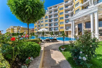 an apartment with a garden and a building at Romantic Studio Florence in Sveti Vlas