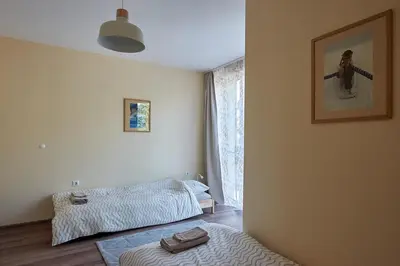 a bedroom with two beds and a window at Green Corner Apartment in the Center - 2BD in Burgas City