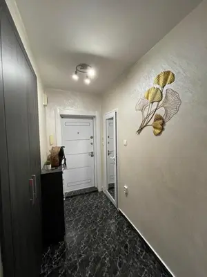 a room with a hallway with a door with a painting on the wall at Sky Sea Apartment in Burgas City