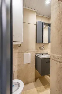 a bathroom with a sink and a toilet at City Center Gem Varna - 5 Guests in Varna City