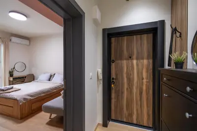 a bedroom with a bed and a sliding door at City Center Gem Varna - 5 Guests in Varna City