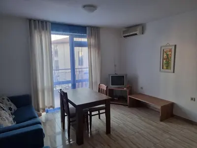 a living room with a table and a couch at Трёхкомнатная квартира in Sveti Vlas