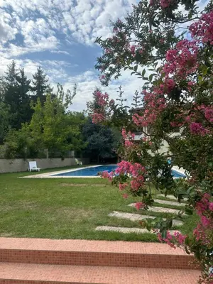 a garden with a swimming pool and pink flowers at Sunny Seasons top view apartment SEA&POOL in Byala