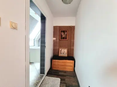 a hallway with a window and a wooden cabinet at Sea Star Studio-to the Sea Garden in Burgas City