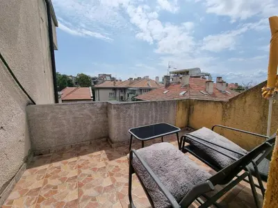 a balcony with chairs and a table on a balcony at Sea Star Studio-to the Sea Garden in Burgas City