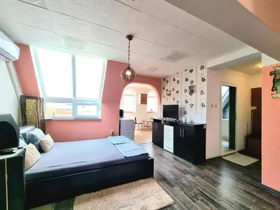 a room with a bed in a room with pink walls at Sea Star Studio-to the Sea Garden in Burgas City